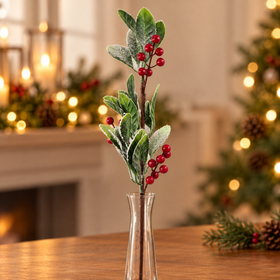 SNOWY CHRISTMAS BRANCH WITH GREEN LEAVES AND RED B SNOWY CHRISTMAS BRANCH WITH GREEN LEAVES AND RED B
